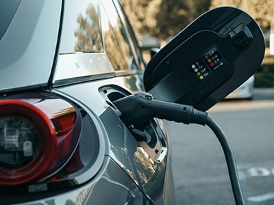 Electric car charger plugged into car